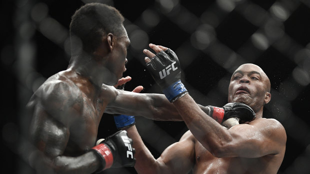 Fight night: Israel Adesanya lands a punch to the throat of Brazil's Anderson Silva in Melbourne.