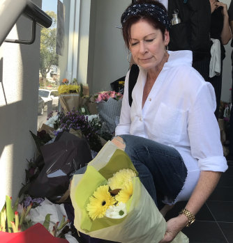 Kerry Gavin lays flowers at the Albanian mosque in Carlton.