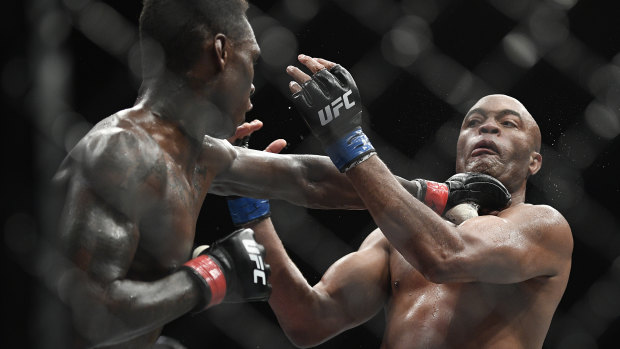 Fight night: Israel Adesanya lands a punch to the throat of Brazil's Anderson Silva in Melbourne.