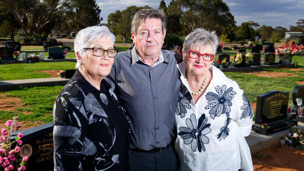 Mary McArthur, Barry White and Colleen Huntington at the cemetery where the body of their brother Peter White was exhumed without their knowledge.