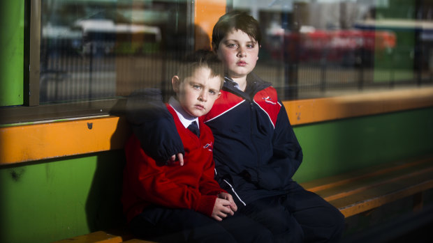 Elijah Sham, 7, and Noah Sham, 10, at the Woden Bus Interchange.