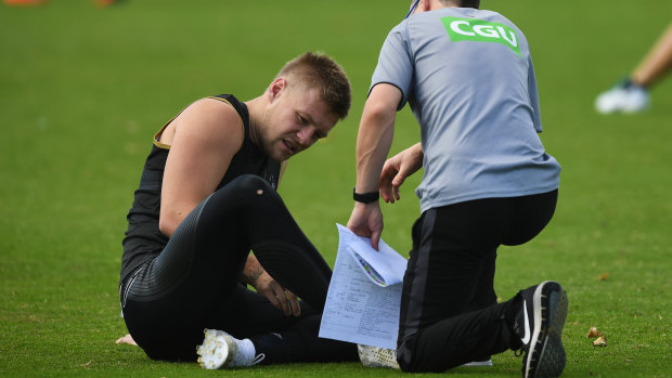 Collingwood's Jordan De Goey gets attention at training on Tuesday.