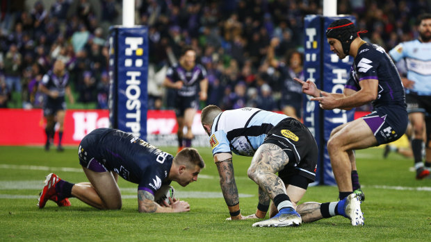 Melbourne Storm's Cameron Munster scores a try against the Sharks in round 17.