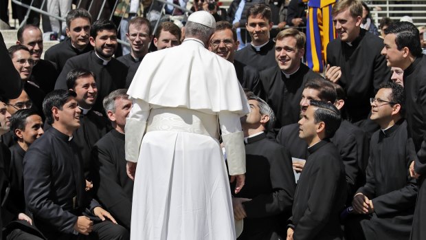 Members of the Legionaries of Christ order kneel in front of Pope Francis at the end of his weekly general audience in St Peter's Square at the Vatican on Wednesday.