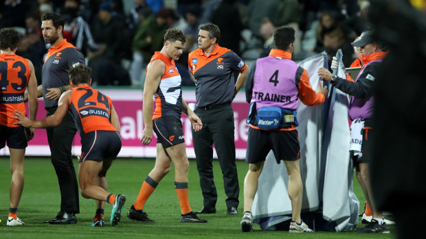 Not happy: Giants coach Leon Cameron, centre, was fuming after his side's heavy loss to the Cats.