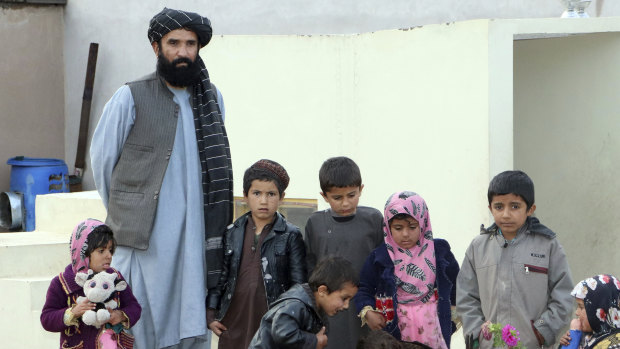 Abdul Manan, a 58-year-old tribal leader, poses with his children. He and an Afghan rights watchdog have are cautiously welcomed a Australian government report into suspected war crimes.