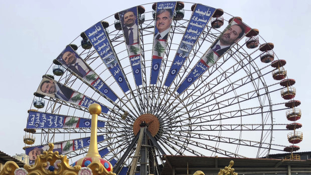 A Beirut Ferris wheel is used in the election campaign of Lebanese Prime Minister Saad Hariri , left.