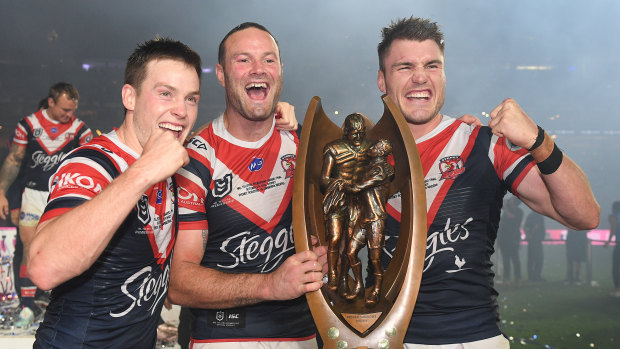 Luke Keary (left) celebrates his third title with Boyd Cordner and Angus Crichton last year.