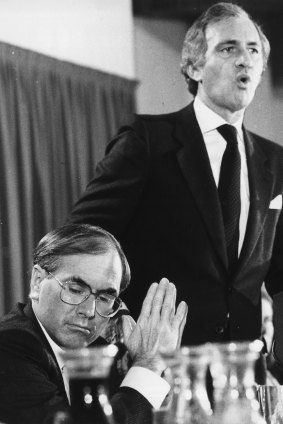 Andrew Peacock launches his economic policy at the National Press Club in 1984 while John Howard listens. 