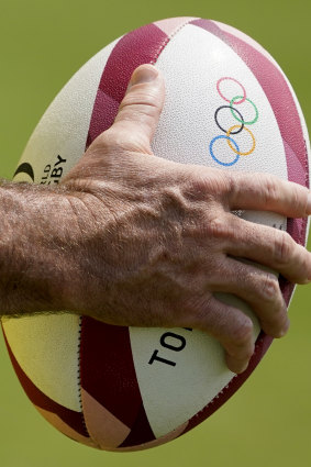 A member of Australia’s men’s rugby sevens team holds a ball during 
a practice session in Tokyo.