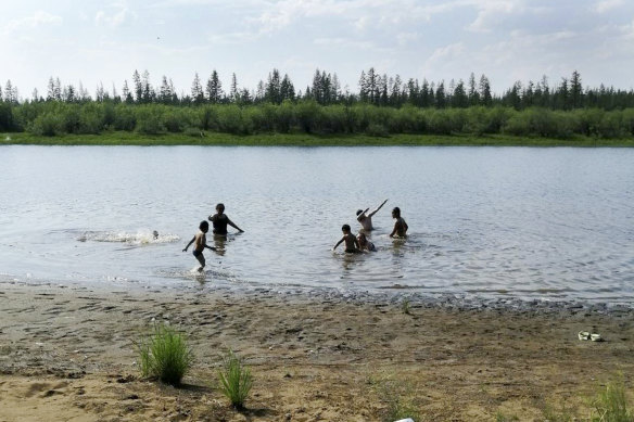 Children play in the Krugloe Lake outside the Arctic town of Verkhoyansk, about 4660 kilometres north of Moscow where the temperature hit 38 degrees this week.