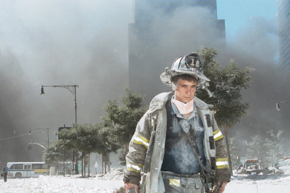 A firefighter walking away from Ground Zero after the collapse of the Twin Towers. 
