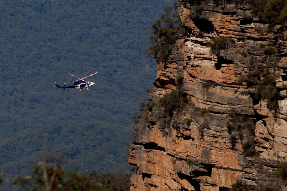 A police air rescue helicopter removes the bodies on Tuesday morning.