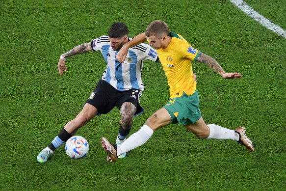 Argentina’s Rodrigo De Paul battles for possession with Riley McGree at the World Cup.