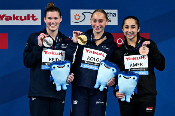 Alysha Koloi (centre) after winning gold at the 2024 world championships. 