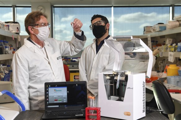 Professor of pharmaceutical biology Colin Pouton and bio-engineer Dr Harry Al-Wassiti with the new  trial COVID-19 vaccine at Monash Institute of Pharmaceutical Sciences. 