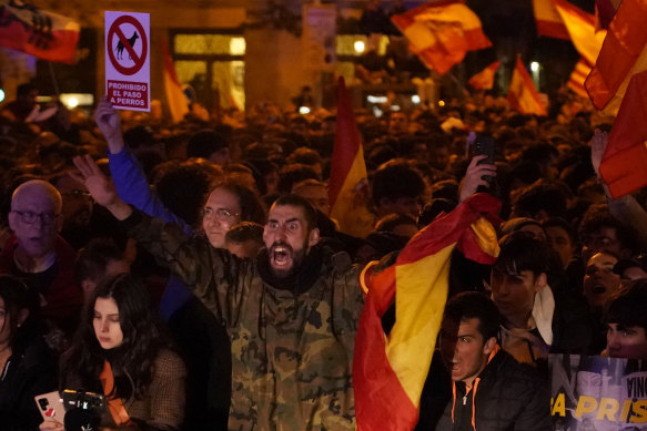 Demonstrators backed by the right-wing Vox Party protest the amnesty deal at the headquarters of Socialist party in Madrid, Spain, on Thursday.