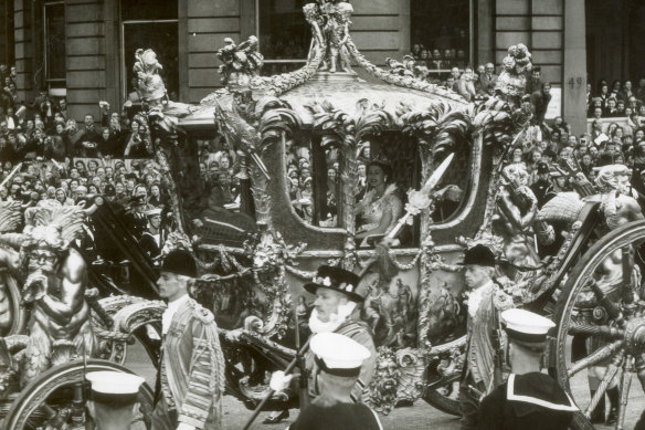 The Queen rides to her coronation in her golden coach.
