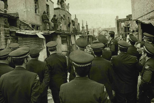 Demonstrators take to the rooftops in their attempt to stop demolition on the Western Expressway site on September 30, 1974.