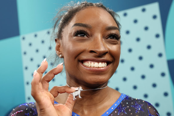 Biles owns being the GOAT, putting on a diamond-encrusted necklace immediately after winning gold.