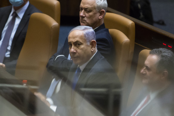 Outgoing Israeli Prime Minister Benjamin Netanyahu looks on after parliament voted to approve the new government and end his 12-year leadership.