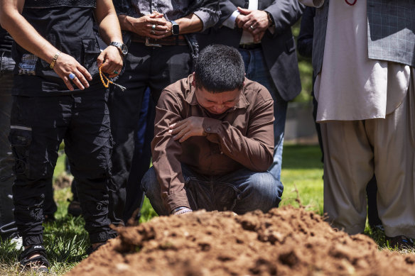 Altaf Hussain cries over the grave of his brother Aftab Hussein at Fairview Memorial Park in Albuquerque, New Mexico.