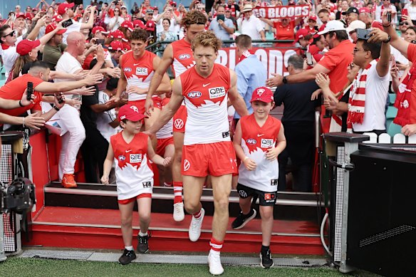 Captain Callum Mills of the Swans leads his team out.