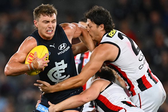 Patrick Cripps attempts to break a tackle against St Kilda.