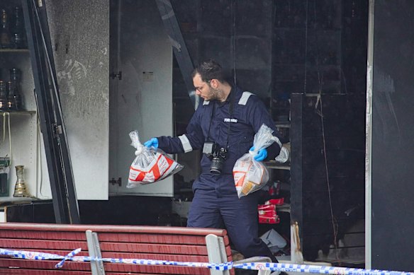 A forensics officer investigating a firebombing at a tobacco store. Police say they are finding more young offenders involved in similar crimes “outsourced” by major gangs.