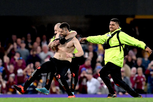 Security tackle a streaker at the Gabba.