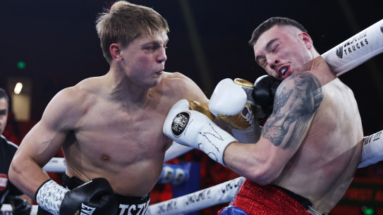 Nikita Tszyu (L) exchanges punches with Benjamin Bommber during their Super-welterweight bout at Margaret Court Arena in Melbourne on May 24.