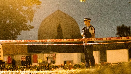 A policeman stands guard at the Al Noor Mosque early on Friday morning.