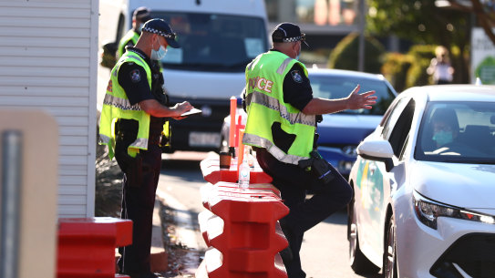 Queensland Police stop cars at the Griffith Street checkpoint in Coolangatta on August 25.