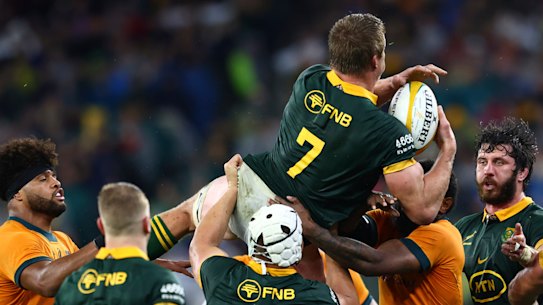 South Africa’s Pieter-Steph du Toit , top, is held up after gathering a high ball against Australia during their rugby union test match in Perth, Saturday, Aug. 17, 2024. (AP Photo/Trevor Collens)
