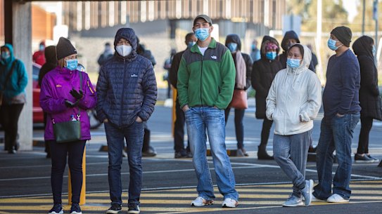 People wait in line to get a COVID-19 vaccine in Melbourne last week.