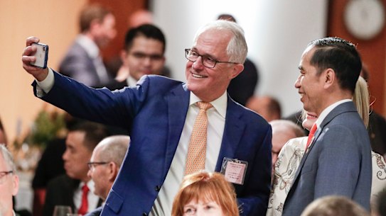 Former Prime Minister Malcolm Turnbull takes a selfie with President of Indonesia Joko Widodo during a luncheon hosted by Prime Minister Scott Morrison at Parliament House in Canberra on Monday.