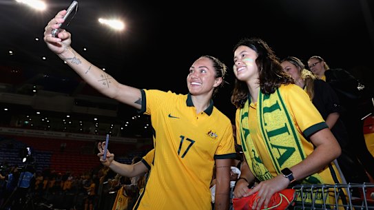 Kyah Simon poses with fans after the second international against the USA in Newcastle.
