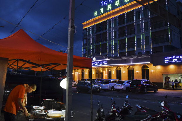 A Chinese food vendor cooks outside a Chinese casino in Sihanoukville.