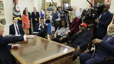 President Donald Trump talks to NFL Hall of Fame football player Jim Brown, seated right, and Rapper Kanye West, seated center, and others in the Oval Office of the White House.