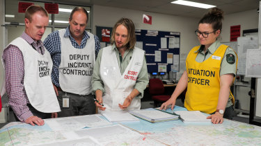 Environment Department incident controller Tim Gazzard (second from right) talks to his team during last year's nurdle emergency in Warrnambool. 