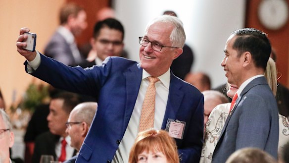 Former prime minister Malcolm Turnbull takes a selfie with President of Indonesia Joko Widodo during a lunch hosted by Prime Minister Scott Morrison at Parliament House in Canberra on Monday.