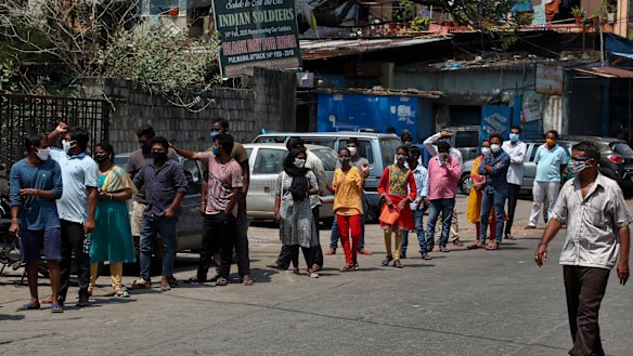 People wait their turn to get tested for COVID-19 in Hyderabad on May 3.