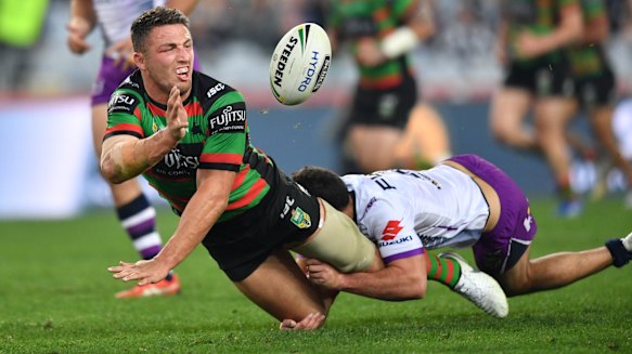 Leader by example: Sam Burgess gets away a flying offload.
