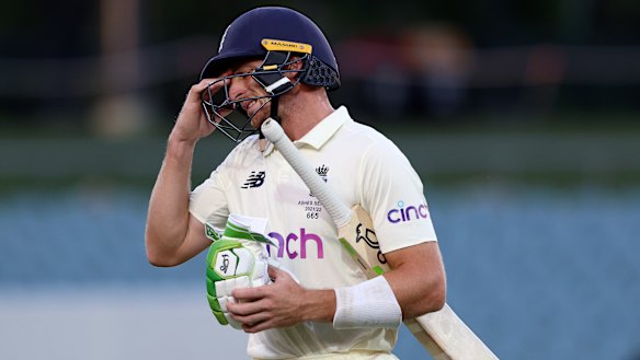 England’s Jos Buttler leaves the field after he is dismissed, hit wicket, during the fifth day of the Adelaide Test.