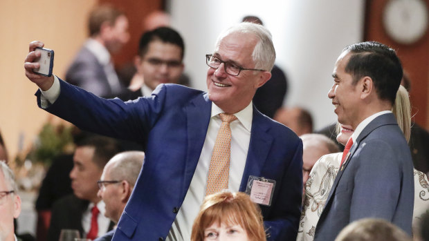 Former prime minister Malcolm Turnbull takes a selfie with President of Indonesia Joko Widodo during a lunch hosted by Prime Minister Scott Morrison at Parliament House in Canberra on Monday.