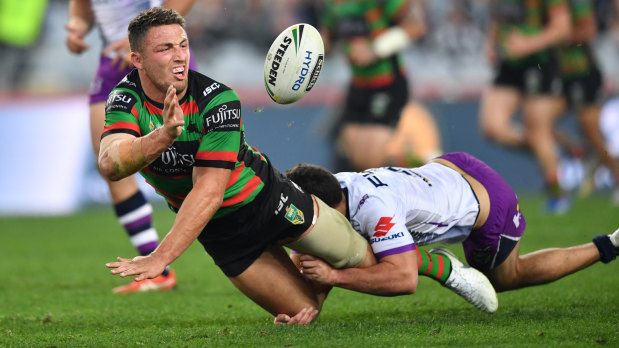 Leader by example: Sam Burgess gets away a flying offload.