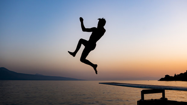 A man jumps into lake Geneva in St Saphorin, Switzerland, to escape the heat.
