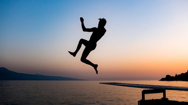 A man jumps into lake Geneva in St Saphorin, Switzerland, to escape the heat.