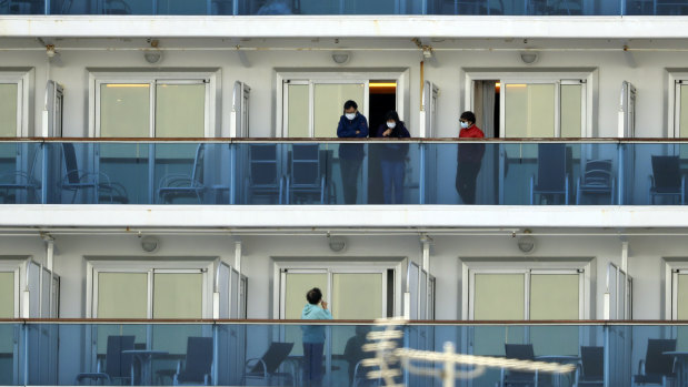 Passengers on balconies of the Diamond Princess cruise ship in Yokohama.