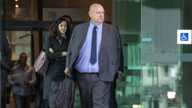 Warren Day (right) of ASIC is seen leaving the Brisbane Magistrate court  after giving evidence at Round 4 of the Royal Commission into Misconduct in the Banking, Superannuation and Financial Services Industry in Brisbane on Monday.